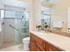 Updated bathroom featuring a glass enclosed shower, tile surround, and granite vanity at 355 Swallow Cir, Venice, FL 34285