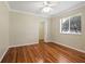 Bedroom with hardwood floors, walk-in closet, a ceiling fan, and a window overlooking the greenery at 355 Swallow Cir, Venice, FL 34285