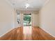 Cozy bedroom with hardwood floors, and sliding glass doors to the pool area at 355 Swallow Cir, Venice, FL 34285