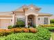 Beautiful single story home with manicured landscaping, a tile roof and a double door front entry at 355 Swallow Cir, Venice, FL 34285