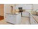 Well-equipped kitchen featuring white cabinets, granite counters, stainless steel appliances, and a center island at 355 Swallow Cir, Venice, FL 34285