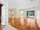 Bright and airy living room with hardwood floors and views to the patio and pool at 355 Swallow Cir, Venice, FL 34285