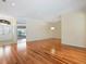 Bright living room with hardwood floors, neutral walls, crown molding, and a glimpse of the front yard through the entry at 355 Swallow Cir, Venice, FL 34285