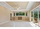Open-concept living area with coffered ceilings, built-in storage, and large windows overlooking the pool at 355 Swallow Cir, Venice, FL 34285