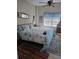 Bright bedroom featuring a comfortable bed with nautical-themed bedding and a ceiling fan at 3730 Cadbury Cir # 703, Venice, FL 34293