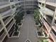 Upper view of an open-air courtyard inside a multi-story condo complex at 3730 Cadbury Cir # 703, Venice, FL 34293