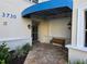 Entrance to the condo features bench seating, a covered entryway and a well-maintained facade at 3730 Cadbury Cir # 703, Venice, FL 34293