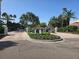 Community entrance with a well-maintained fountain, landscaping, and palm trees at 3730 Cadbury Cir # 703, Venice, FL 34293