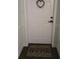 A welcoming white front door with a decorative wreath and a 'HOME' doormat at 3730 Cadbury Cir # 703, Venice, FL 34293