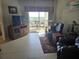 Inviting living room with comfortable leather seating and a view of the outdoor balcony at 3730 Cadbury Cir # 703, Venice, FL 34293