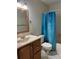 Standard bathroom with a single sink vanity, mirror, and blue patterned shower curtain at 3862 59Th W Ave # 4180, Bradenton, FL 34210