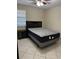 Bedroom featuring neutral walls, tile flooring, ceiling fan, and a window for natural light at 3862 59Th W Ave # 4180, Bradenton, FL 34210