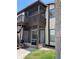Two-story condo featuring a screened patio and balcony with dark brown trim and neutral-colored siding at 3862 59Th W Ave # 4180, Bradenton, FL 34210