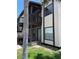 Two-story exterior featuring white siding, dark brown trim, stairs, balconies, and well-maintained landscaping at 3862 59Th W Ave # 4180, Bradenton, FL 34210