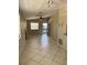 Spacious living room with neutral paint, tile floors, ceiling fan, and a door to a private screened porch at 3862 59Th W Ave # 4180, Bradenton, FL 34210