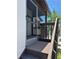 Screened porch with dark trim on second floor with stairs leading up to a light textured condo at 3862 59Th W Ave # 4180, Bradenton, FL 34210