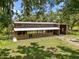 Aerial view of a barn-style home featuring a metal roof and surrounding lush green landscape at 3863 Albin Ave, North Port, FL 34286