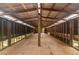 Spacious barn interior with plywood floors and exposed beam construction, perfect for converting to stalls at 3863 Albin Ave, North Port, FL 34286