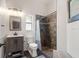 Well-lit bathroom with a tile shower and rustic vanity at 3863 Albin Ave, North Port, FL 34286