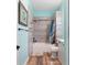 Bathroom with a tub and shower featuring decorative horizontally laid tiling and a teal colored ceiling at 3863 Albin Ave, North Port, FL 34286