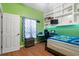 Bright bedroom view with gaming desk, hardwood floor, and decoratively themed curtains at 3863 Albin Ave, North Port, FL 34286