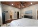 Bedroom with wood floors, a ceiling fan and great natural light with a view to an attached bathroom at 3863 Albin Ave, North Port, FL 34286