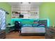 View of a bright bedroom with a bed, desk and built-in shelves with LED accent lighting at 3863 Albin Ave, North Port, FL 34286