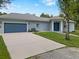 Single-story home with a well-manicured front yard and a three car garage at 3863 Albin Ave, North Port, FL 34286