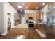 A spacious kitchen with an island, stainless steel appliances, wood cabinets, and beautiful wood floors at 3863 Albin Ave, North Port, FL 34286