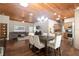 Spacious living room and kitchen with wood ceiling, modern lighting, and stainless appliances at 3863 Albin Ave, North Port, FL 34286