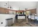 Open-concept living room with tile flooring, multiple ceiling fans, and abundant natural light at 3863 Albin Ave, North Port, FL 34286