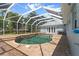 Screened-in in-ground pool with brick patio and luxurious seating area at 3863 Albin Ave, North Port, FL 34286