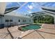 In-ground pool with brick patio surrounded by a screened enclosure, luxurious backyard at 3863 Albin Ave, North Port, FL 34286