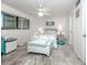 Cozy bedroom with neutral tones, a ceiling fan, and bright natural light at 401 Airport E Ave # 304, Venice, FL 34285
