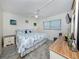 Serene bedroom featuring beach decor, natural light, and comfortable furnishing at 401 Airport E Ave # 304, Venice, FL 34285