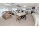 Spacious community room with tables, chairs, and couch, ideal for gatherings and events at 401 Airport E Ave # 304, Venice, FL 34285