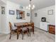 Cozy dining area with a wooden table, seating for four, and a view into the kitchen, creating a welcoming space at 401 Airport E Ave # 304, Venice, FL 34285