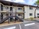Building exterior with stairs leading to upper units and parking space, showcases practical design and accessibility at 401 Airport E Ave # 304, Venice, FL 34285