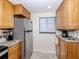 Functional kitchen with stainless steel refrigerator, granite counters, and ample cabinet space at 401 Airport E Ave # 304, Venice, FL 34285