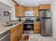 Well-lit kitchen with stainless steel appliances and granite countertops offers modern convenience at 401 Airport E Ave # 304, Venice, FL 34285