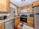 Bright kitchen featuring stainless steel appliances, granite counters, and light wood cabinetry at 401 Airport E Ave # 304, Venice, FL 34285