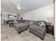 Open-concept living room with sectional sofa seamlessly flows into the dining area, ideal for entertaining and gatherings at 401 Airport E Ave # 304, Venice, FL 34285
