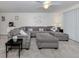 Spacious living room with a generous sectional sofa, neutral tones, and comfortable seating arrangements at 401 Airport E Ave # 304, Venice, FL 34285