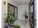 Cozy patio with lush plants and lots of natural light, a serene and inviting outdoor space at 401 Airport E Ave # 304, Venice, FL 34285