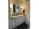 Enjoy the bright ensuite bathroom with a modern vanity, ample storage, and decorative lighting fixtures at 411 Vasto Dr, Venice, FL 34285