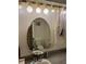 Bathroom with an oval mirror and white cabinets at 411 Vasto Dr, Venice, FL 34285