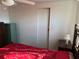 A bedroom featuring neutral walls with white trim and a storage closet at 411 Vasto Dr, Venice, FL 34285