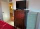 Bedroom featuring a dresser with a TV and ensuite bathroom at 411 Vasto Dr, Venice, FL 34285