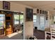 Sunlit dining area showcases display cabinet and transitions to a carpeted living space at 411 Vasto Dr, Venice, FL 34285