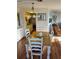 Cozy dining room featuring a wood table with white chairs and plenty of natural light at 411 Vasto Dr, Venice, FL 34285